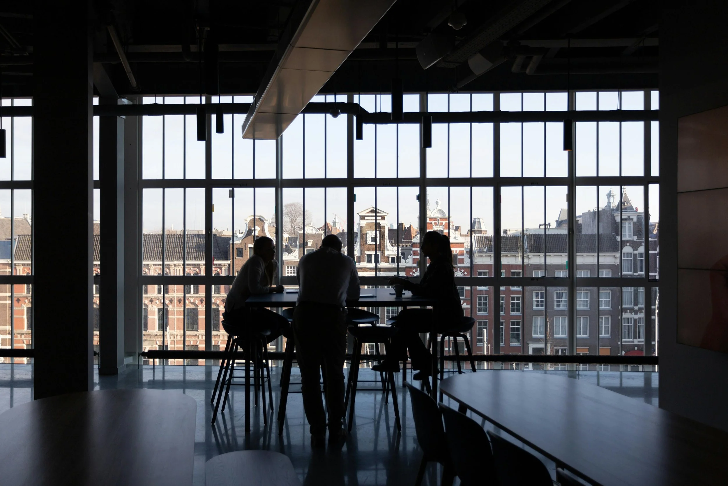 Silhouetted team in a boardroom meeting